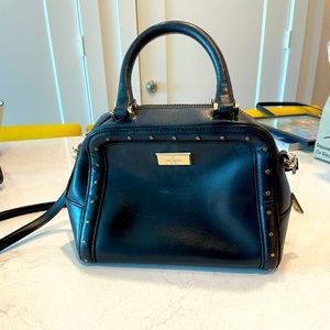Black Kate Spade handbag with gold accents and removeable strap